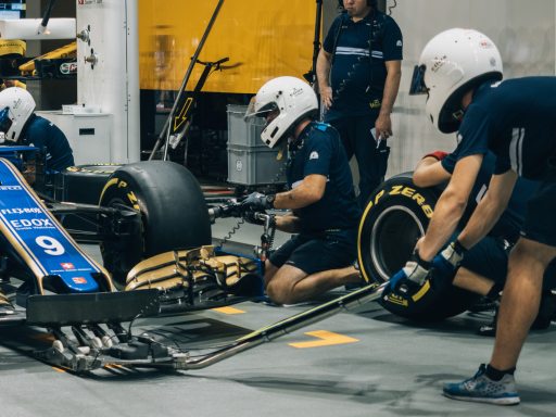 Mechanics changing wheels on car